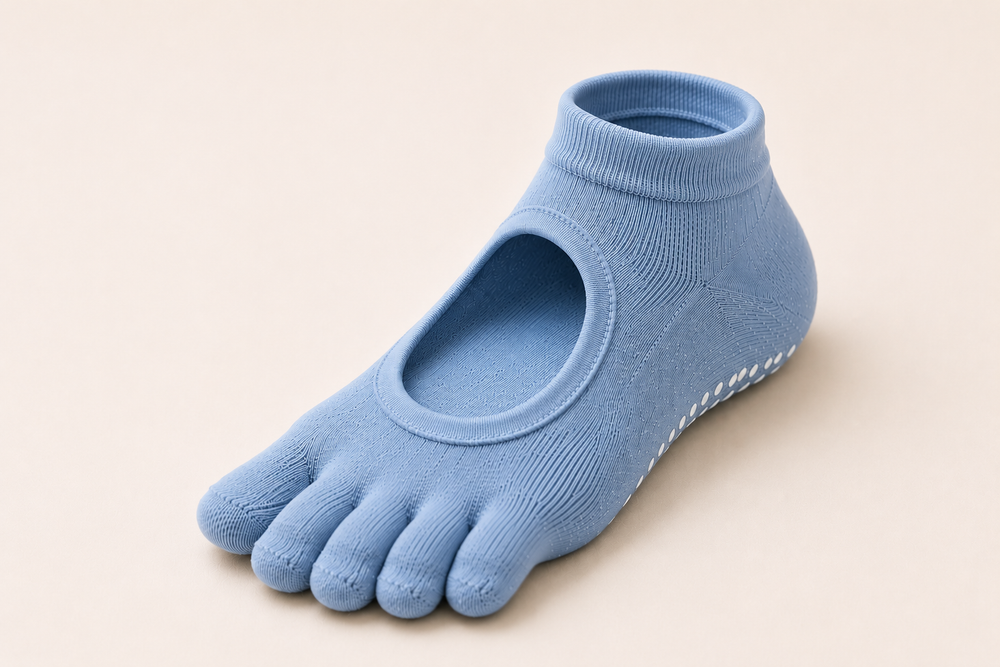 Five-toe pilates grip socks worn during a studio workout